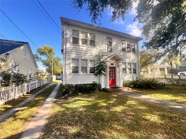 a view of a house with a yard