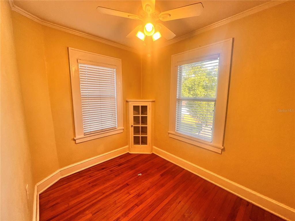 617 North Hyer Avenue, Unit 3 Orlando, FL 32803 - Photo 8 of 13 a view of an empty room with wooden floor and a window
