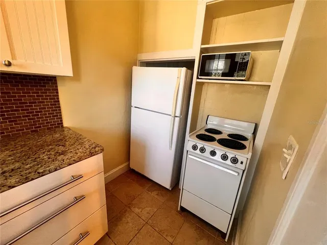a kitchen with a stove microwave and refrigerator