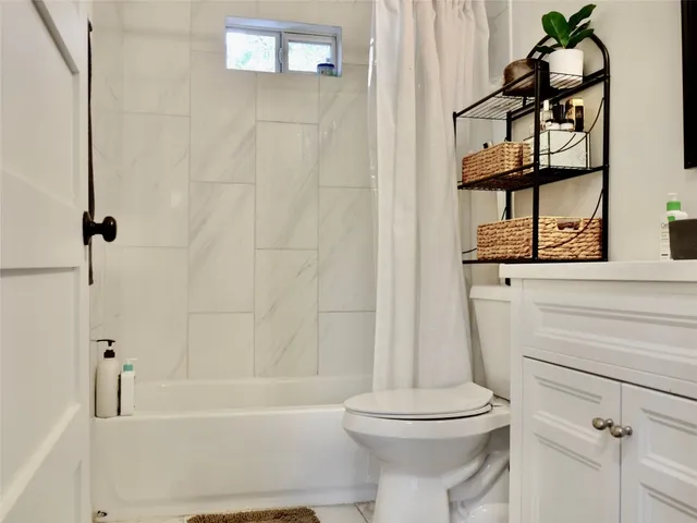 a bathroom with a sink a toilet and bathtub