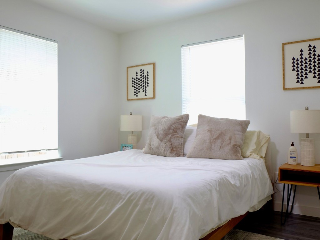 1401 Marcus Place, Unit B Austin, TX 78721 - Photo 21 of 38 a bedroom with a bed and a lamp on dresser