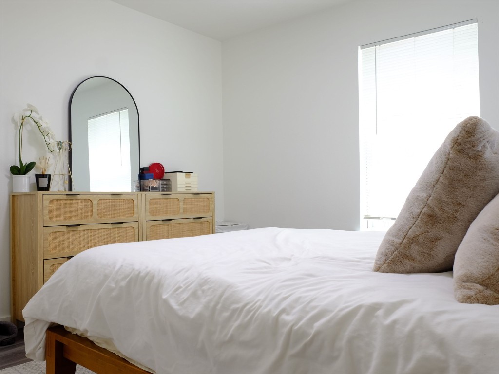 1401 Marcus Place, Unit B Austin, TX 78721 - Photo 22 of 38 a bedroom with a bed and a dresser