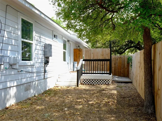 a view of a house with a wooden fence