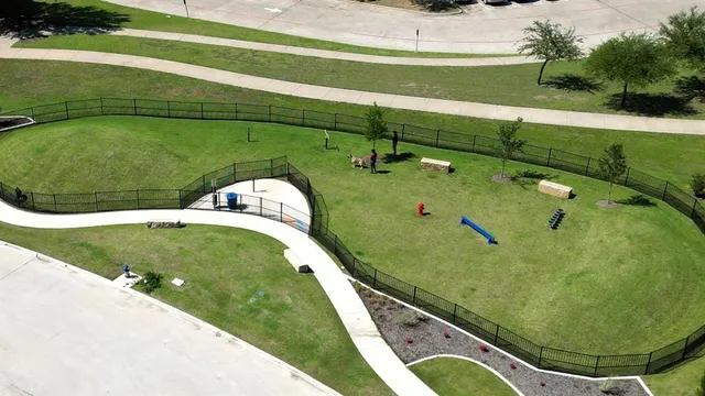 an aerial view of a house with a swimming pool and fire pit