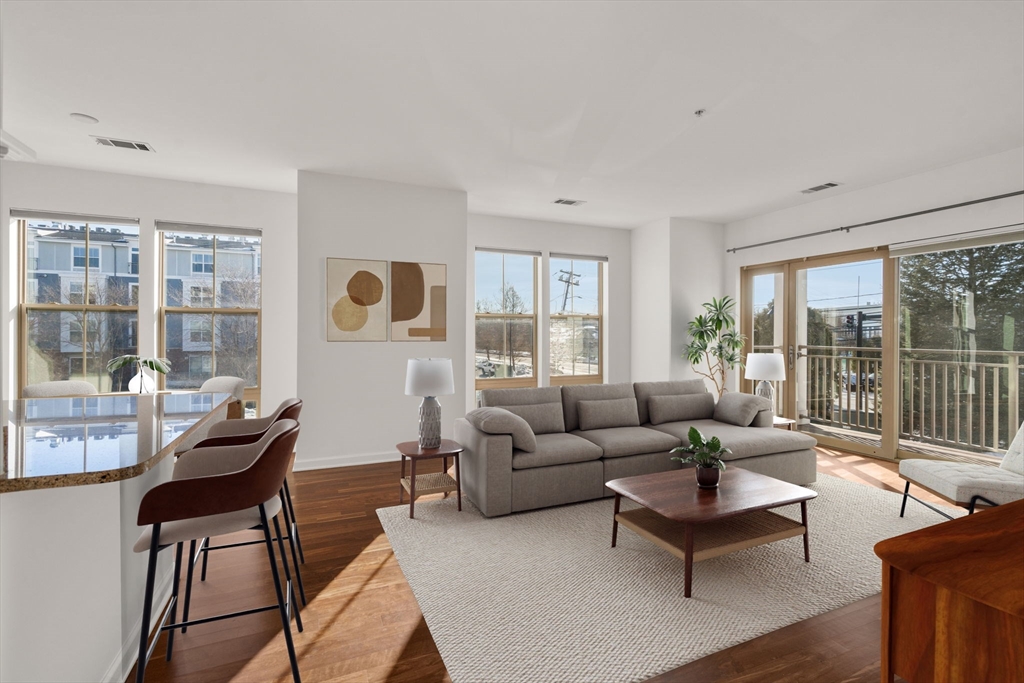 a living room with furniture and a floor to ceiling window