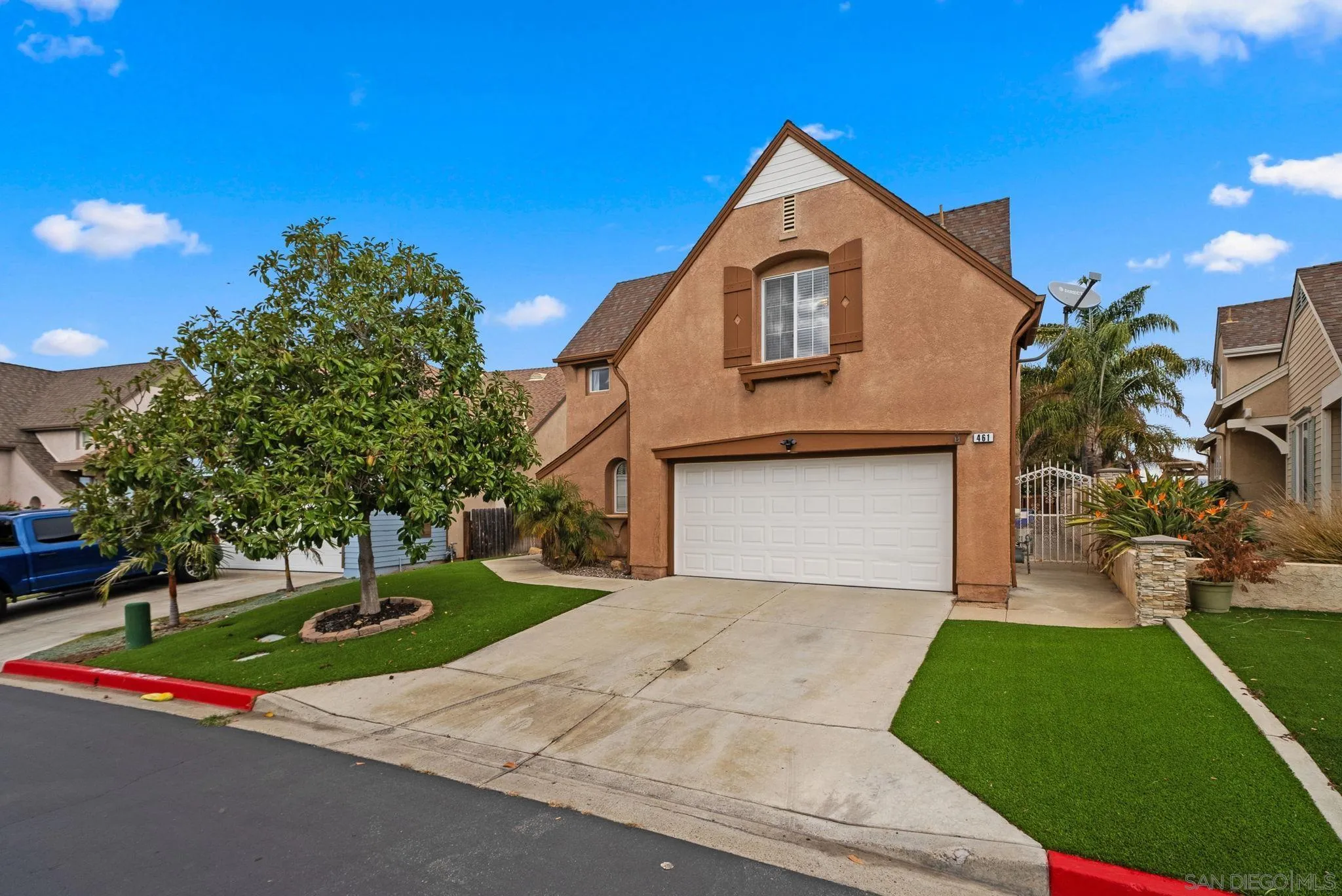 461 Poets Square Fallbrook, CA 92028 - Photo 1 of 40 a front view of a house with a yard and garage