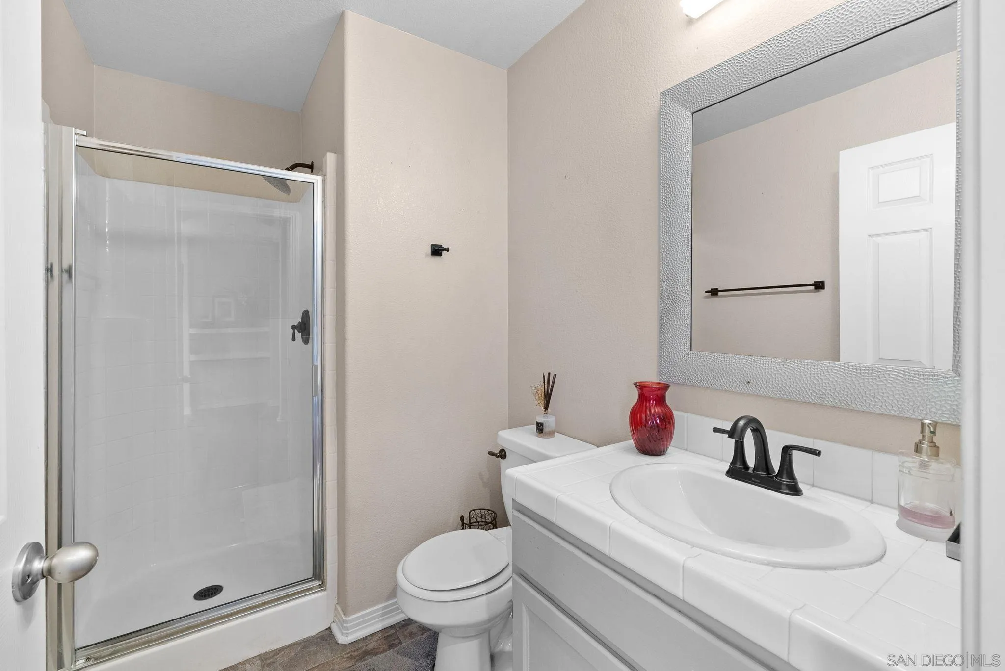 461 Poets Square Fallbrook, CA 92028 - Photo 17 of 40 a white toilet sitting next to a bathroom sink