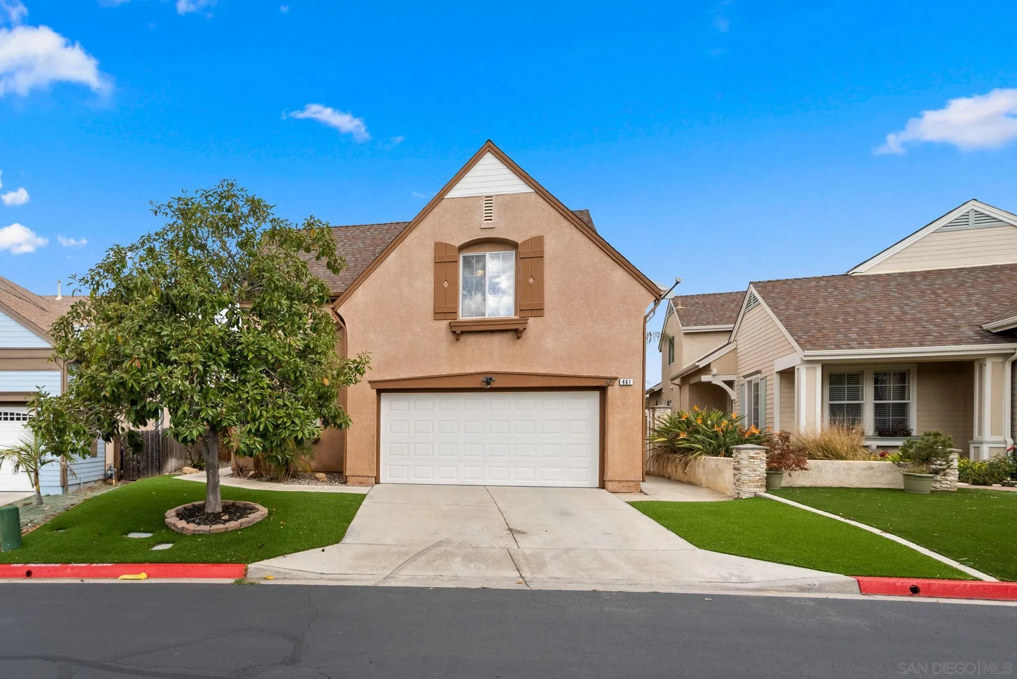 461 Poets Square Fallbrook, CA 92028 - Photo 2 of 40 a front view of a house with a yard and garage