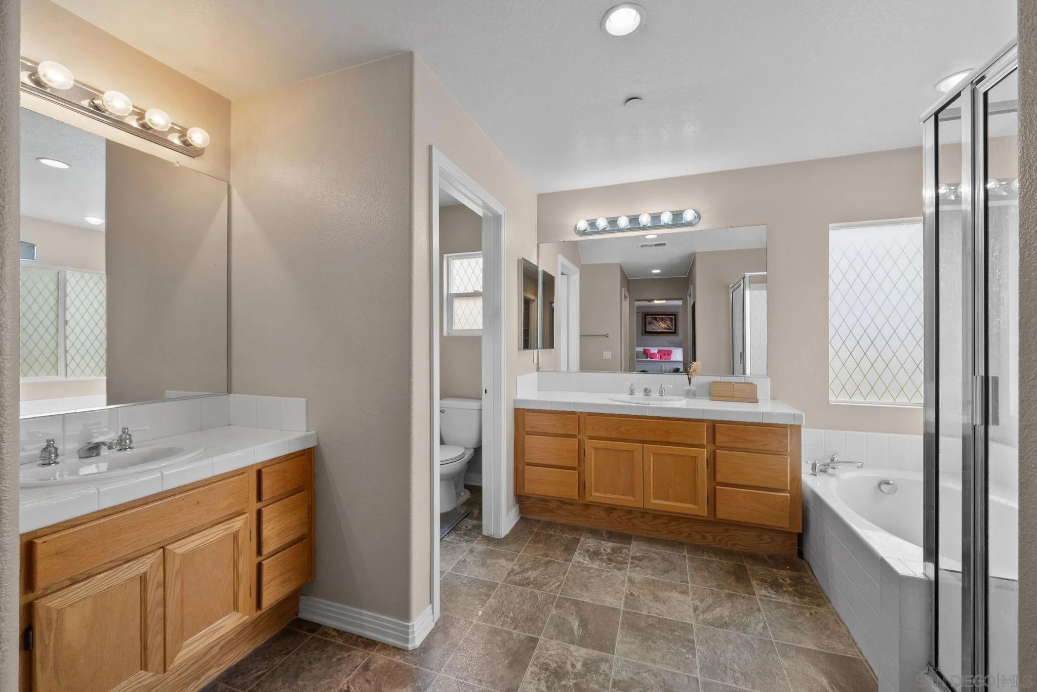 461 Poets Square Fallbrook, CA 92028 - Photo 22 of 40 a bathroom with a granite countertop sink mirror and bathtub