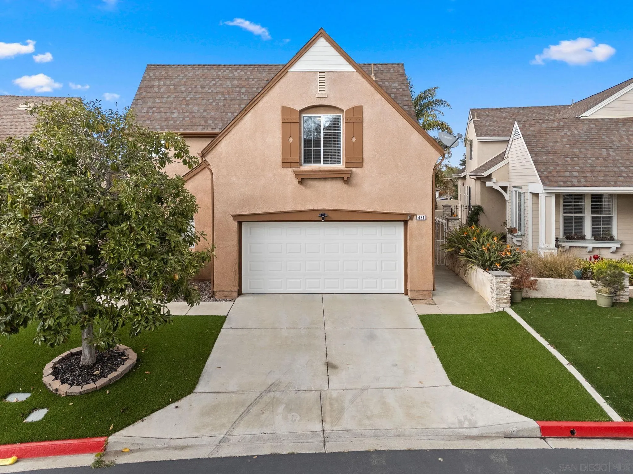 461 Poets Square Fallbrook, CA 92028 - Photo 3 of 40 a front view of a house with a yard and garage