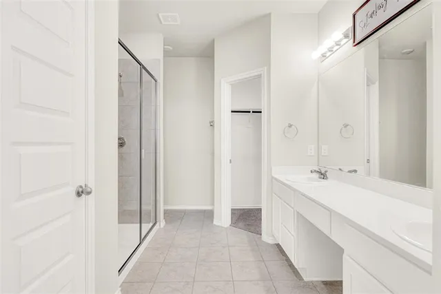 a bathroom with a double vanity sink a mirror and a shower