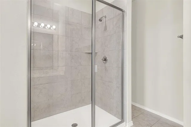 a bathroom with a glass shower door