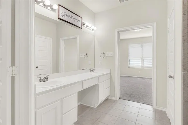 a spacious bathroom with a mirror sink and shower