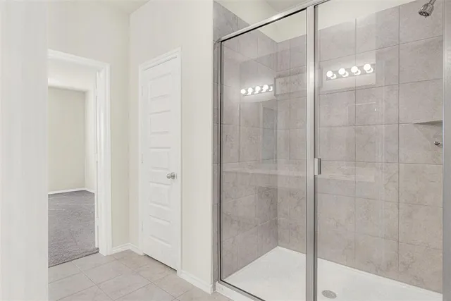 a bathroom with a glass shower door