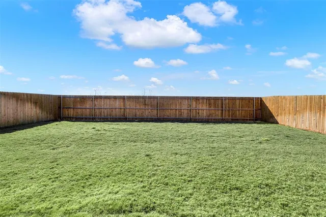 a view of backyard with green space