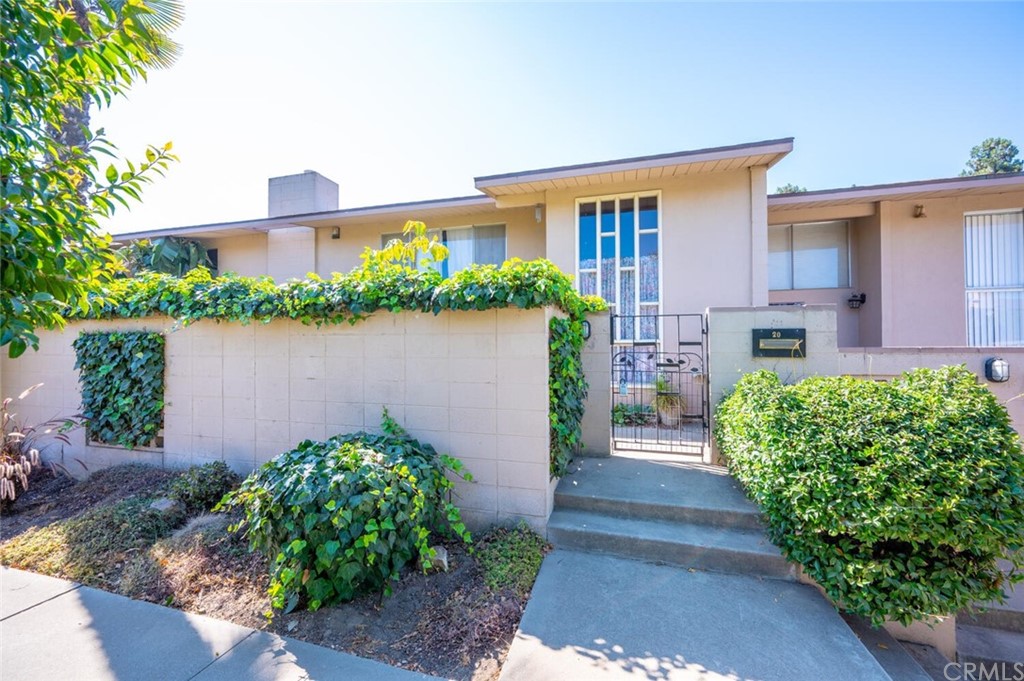715 South Bradley Road, Unit 20 Santa Maria, CA 93454 - Photo 1 of 1 a front view of a house with a yard and potted plants