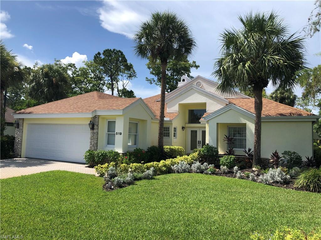 a front view of house with yard and green space