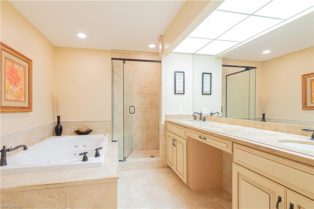 519 Cormorant Cove Naples, FL 34113 - Photo 16 of 32 a spacious bathroom with a sink double vanity and a mirror