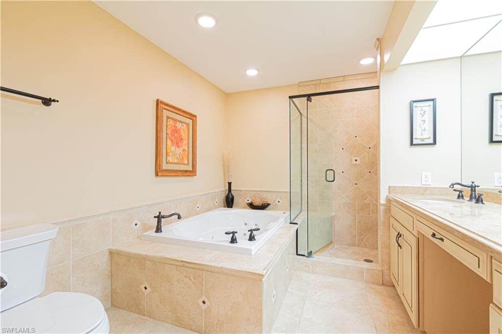 519 Cormorant Cove Naples, FL 34113 - Photo 17 of 32 a bathroom with a sink a toilet and shower