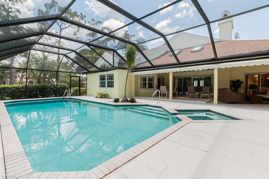 519 Cormorant Cove Naples, FL 34113 - Photo 25 of 32 a view of a swimming pool with a patio