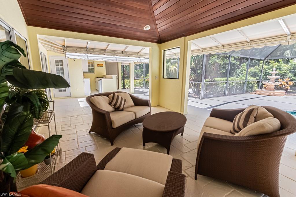 519 Cormorant Cove Naples, FL 34113 - Photo 26 of 32 a living room with furniture and a large window