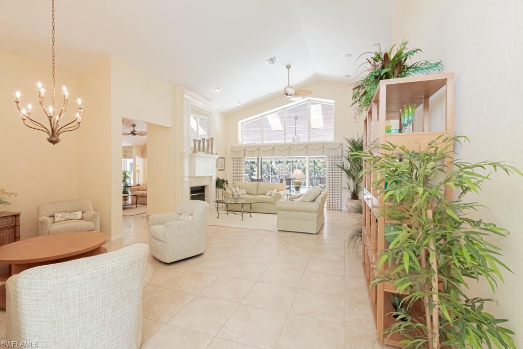 519 Cormorant Cove Naples, FL 34113 - Photo 3 of 32 a living room with furniture and a chandelier