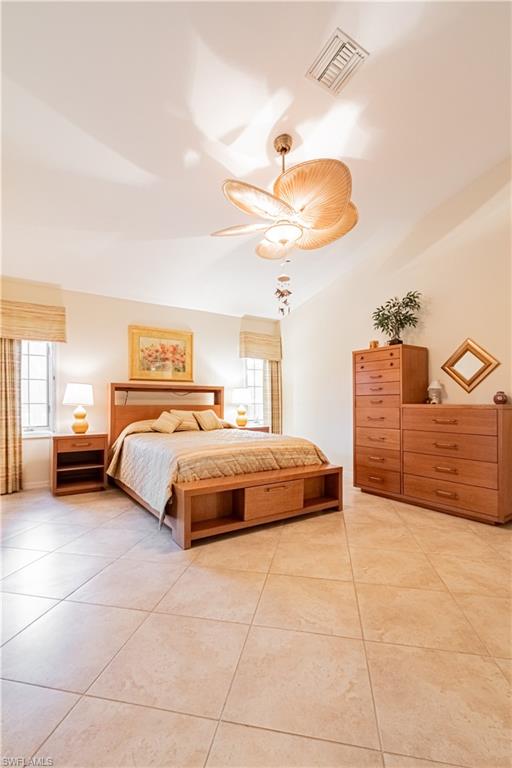 519 Cormorant Cove Naples, FL 34113 - Photo 10 of 32 a bedroom with a bed and ceiling fan