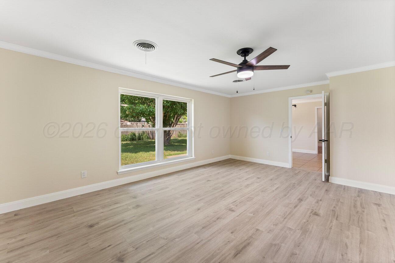 7204 Southwest 39th Avenue Amarillo, TX 79109 - Photo 23 of 51 a view of a room with wooden floor and a ceiling fan