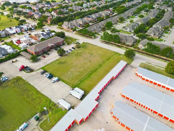 an aerial view of a pool an outdoor space and seating area