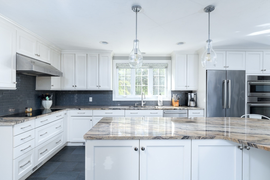 27 Vista Circle Rutland, MA 01543 - Photo 6 of 35 a kitchen with kitchen island granite countertop a sink a counter space appliances and cabinets