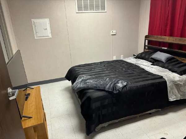 a bedroom with a bed and a mirror