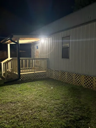 a view of a yard with wooden fence