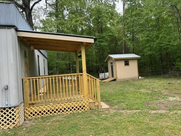 a view of a chair and table in the backyard