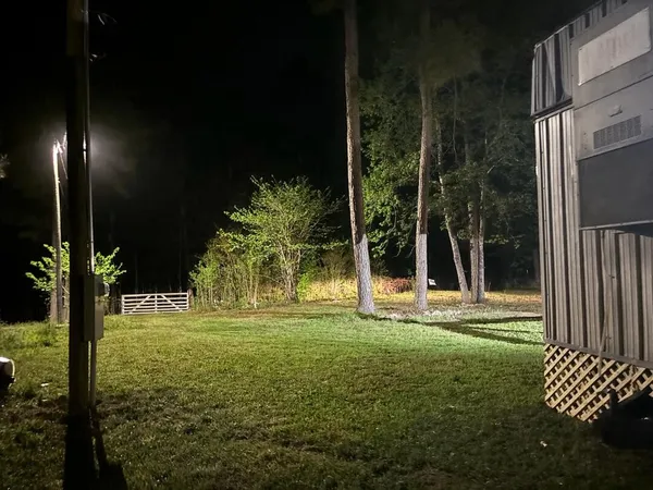a backyard of a house with lots of green space and outdoor seating