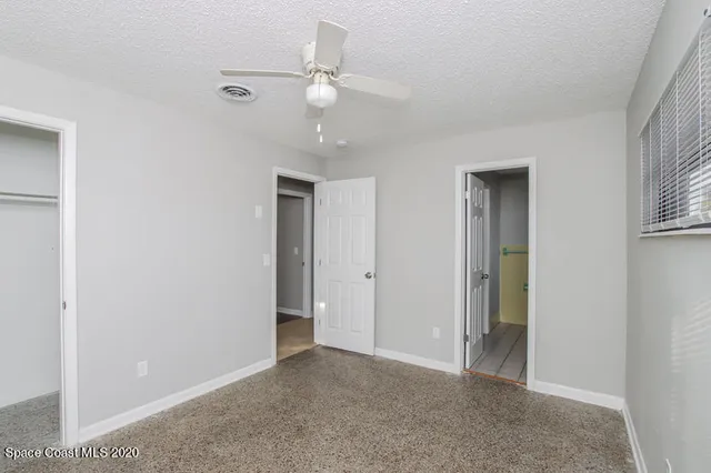 a view of an empty room with a fan