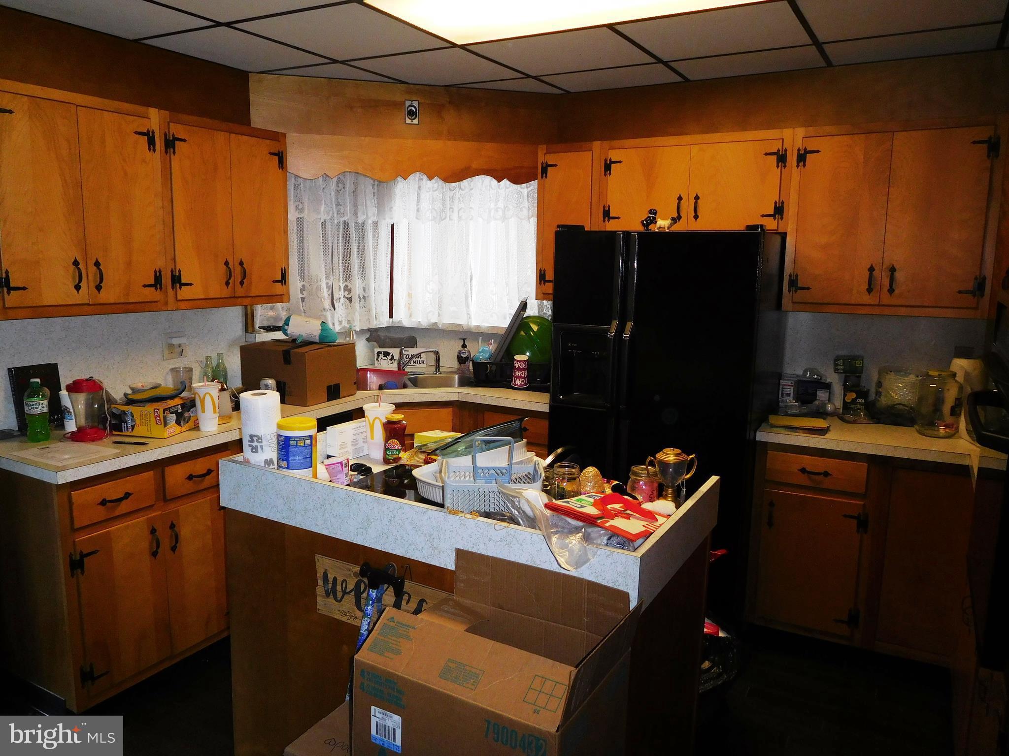 14920 Cemetery Road Midland, MD 21532 - Photo 5 of 26 a kitchen with stainless steel appliances a refrigerator sink and cabinets