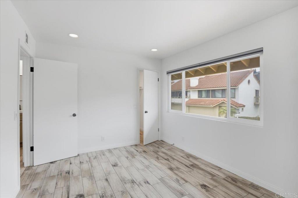 6686 Corte Maria Carlsbad, CA 92009 - Photo 17 of 28 a view of an empty room with wooden floor and a window