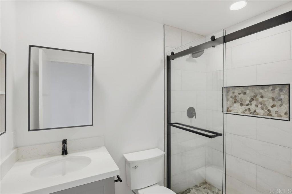 6686 Corte Maria Carlsbad, CA 92009 - Photo 18 of 28 a bathroom with a sink toilet and shower