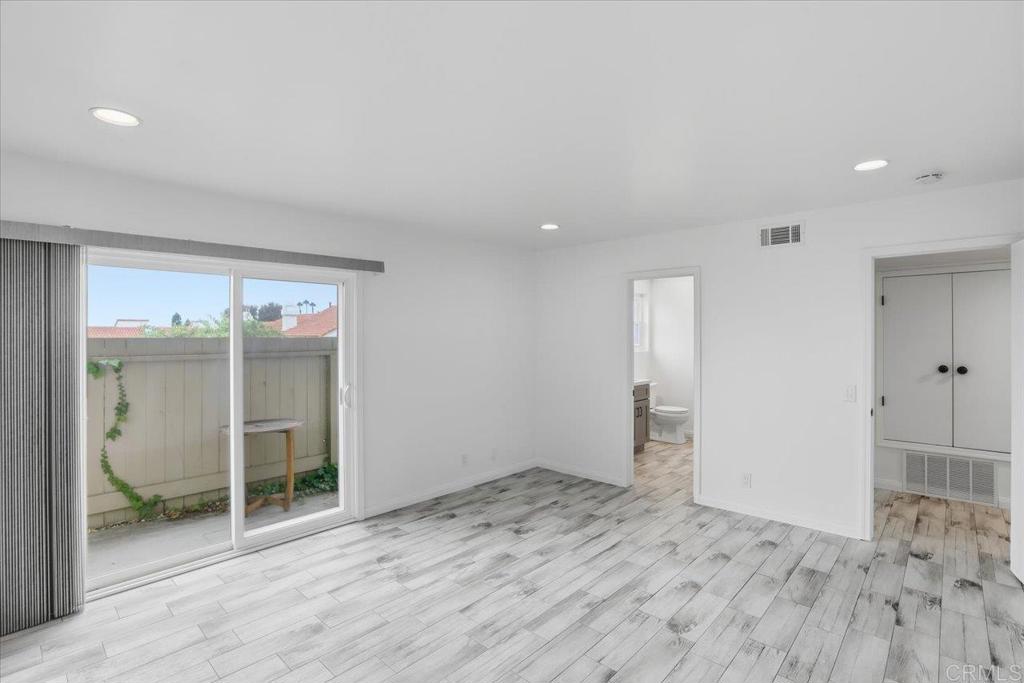 6686 Corte Maria Carlsbad, CA 92009 - Photo 21 of 28 an empty room with wooden floor and windows