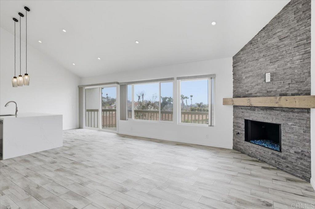6686 Corte Maria Carlsbad, CA 92009 - Photo 6 of 28 a view of an empty room with a fireplace and a window