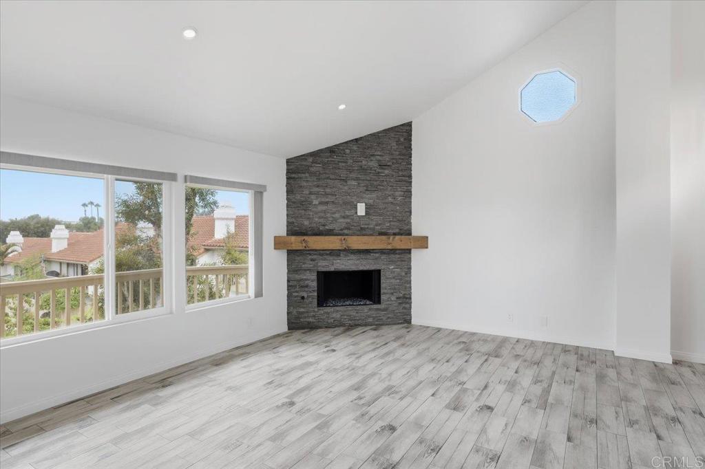 6686 Corte Maria Carlsbad, CA 92009 - Photo 8 of 28 wooden floor fireplace and windows in an empty room