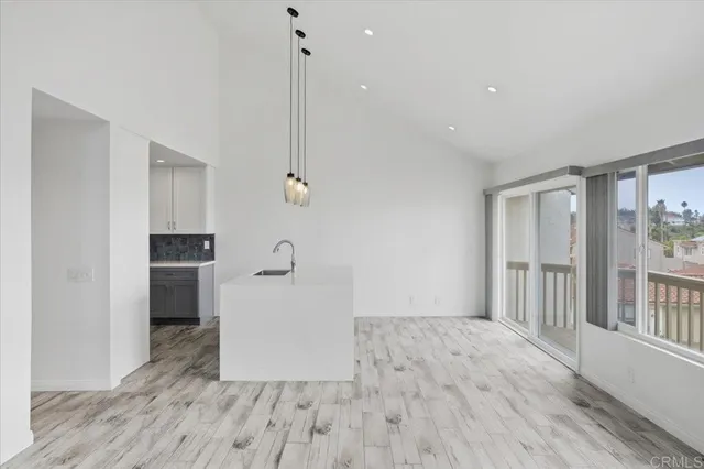 a view of empty room with wooden floor and window