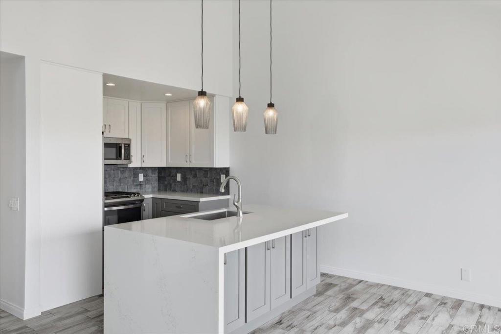 6686 Corte Maria Carlsbad, CA 92009 - Photo 10 of 28 a kitchen with cabinets a sink and dishwasher