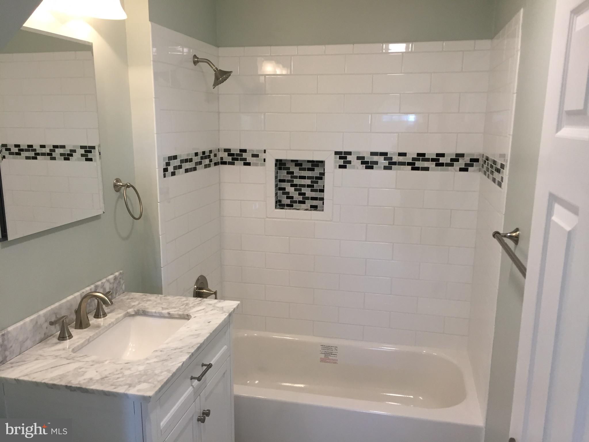 1517 Rita Road Baltimore, MD 21222 - Photo 11 of 12 a bathroom with a granite countertop sink toilet and shower