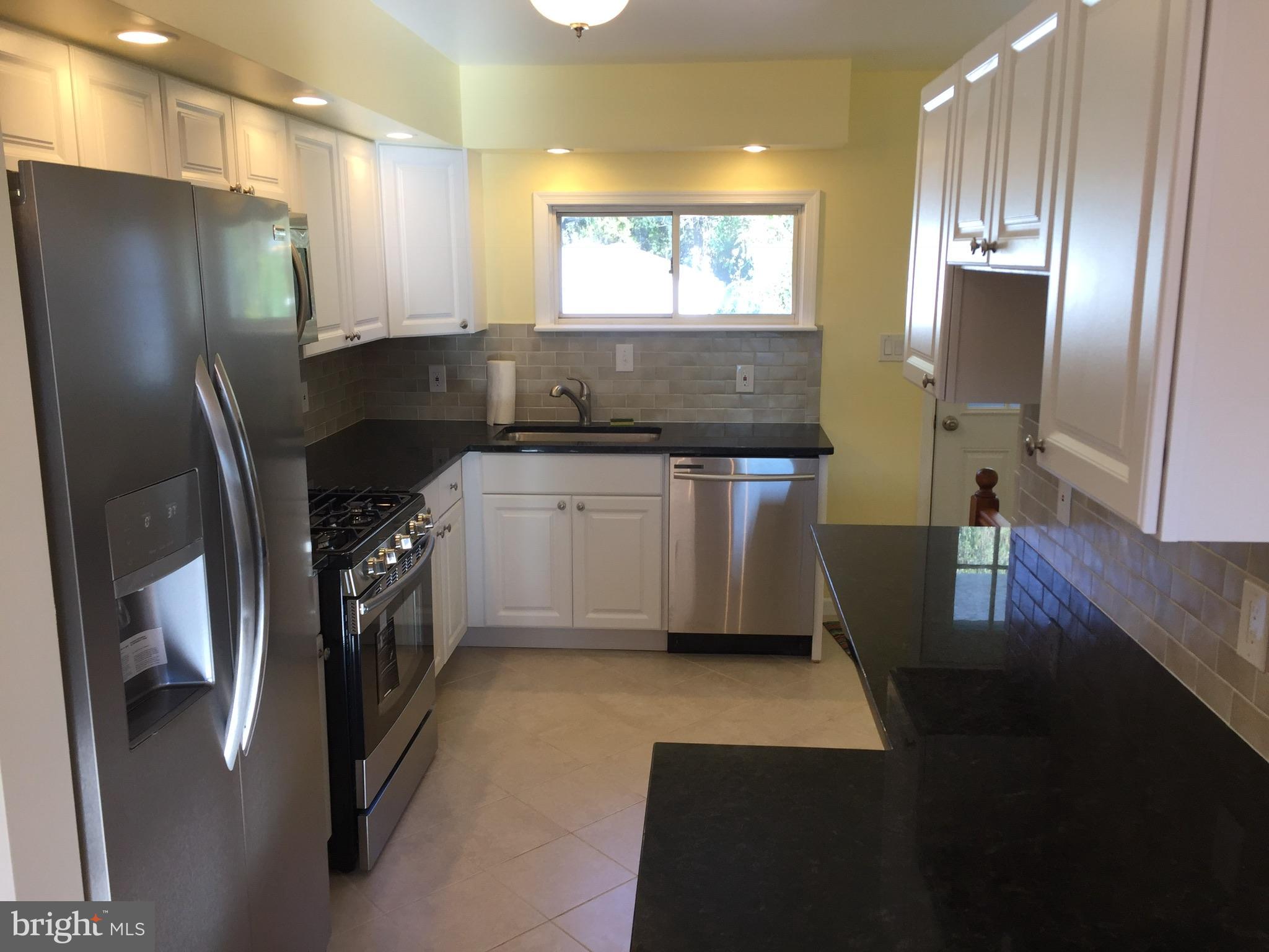 1517 Rita Road Baltimore, MD 21222 - Photo 5 of 12 a kitchen with stainless steel appliances a refrigerator sink and wooden floor