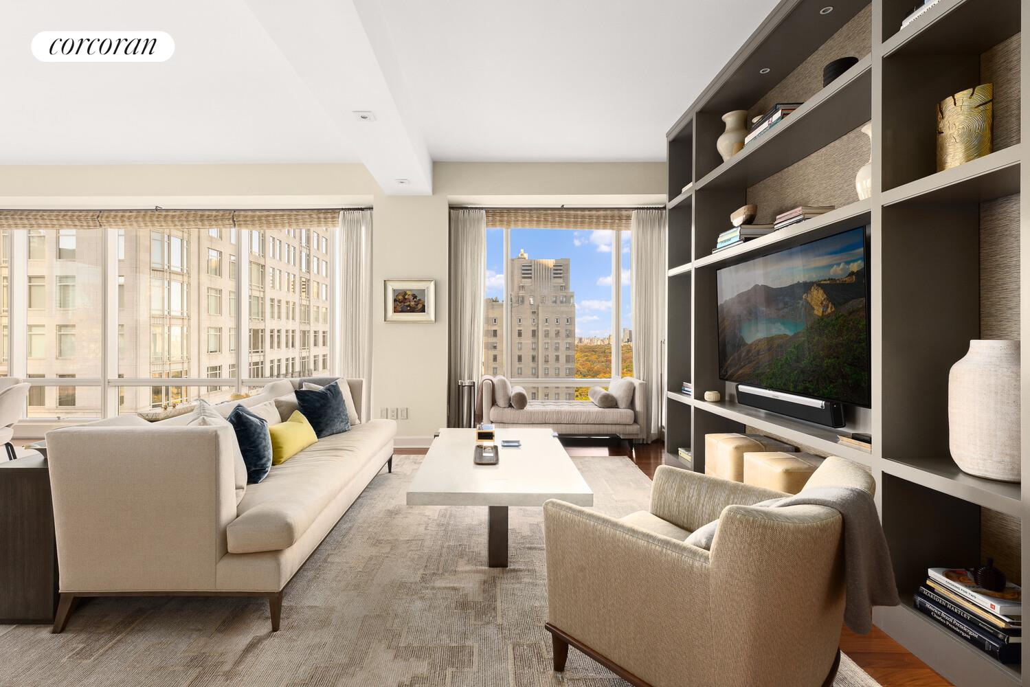 1 Central Park West, Unit 30G Manhattan, NY 10023 - Photo 2 of 10 a living room with furniture and a flat screen tv