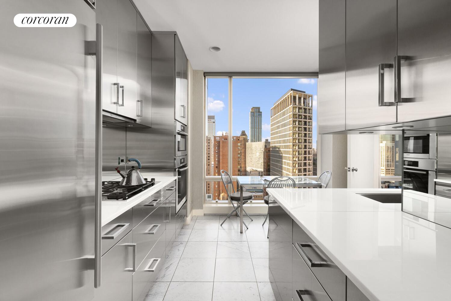 1 Central Park West, Unit 30G Manhattan, NY 10023 - Photo 3 of 10 a large kitchen with kitchen island a large window