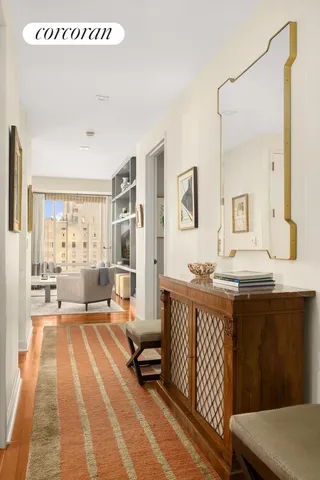 a living room with furniture a flat screen tv and a floor to ceiling window