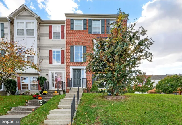 front view of a brick house with a yard