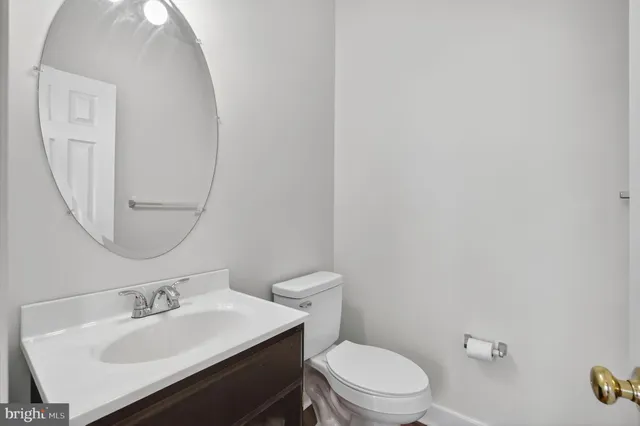 a bathroom with a sink a toilet and mirror